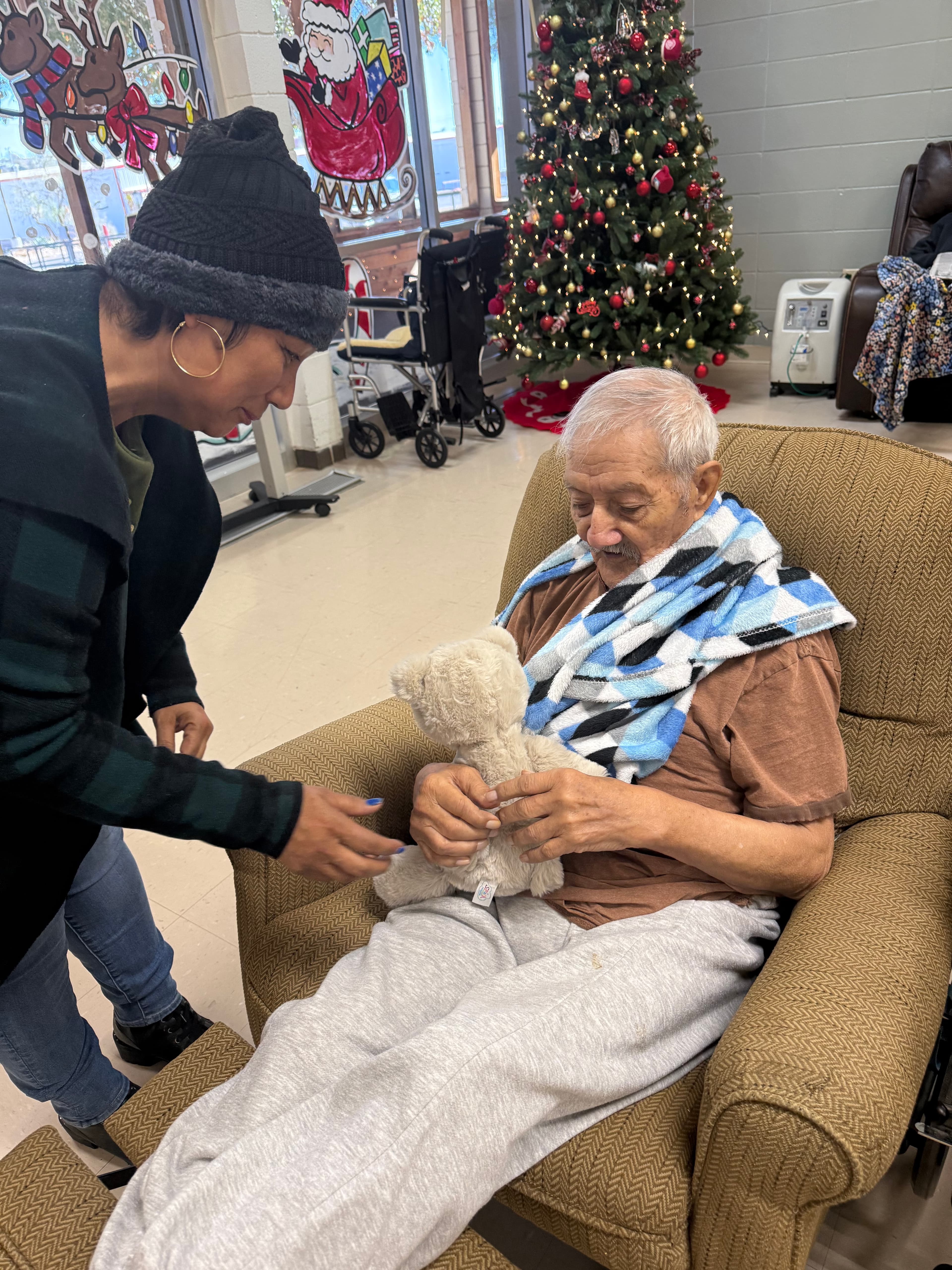 Templo Siloe sharing a Christmas visit with an elderly community member.